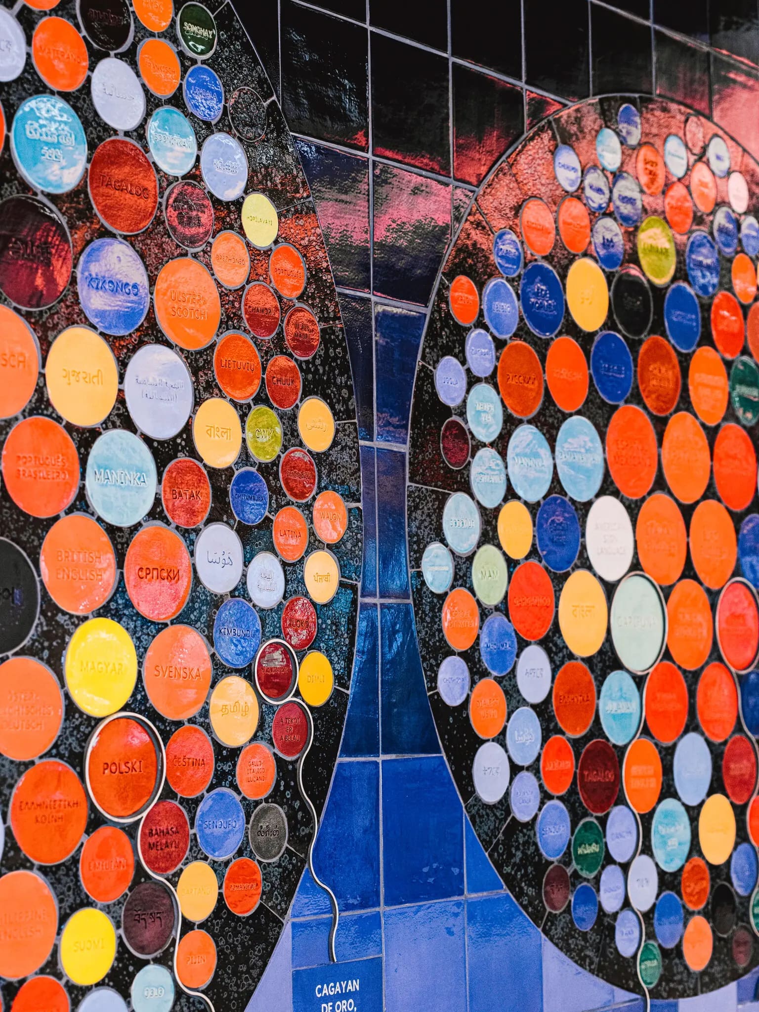 Mariam Ghani, The Worlds We Speak, 2022. Debossed ceramic tile, brushed steel. Commissioned by Delta Air Lines in partnership with Queens Museum, New York. Photo: Rank Studios.
