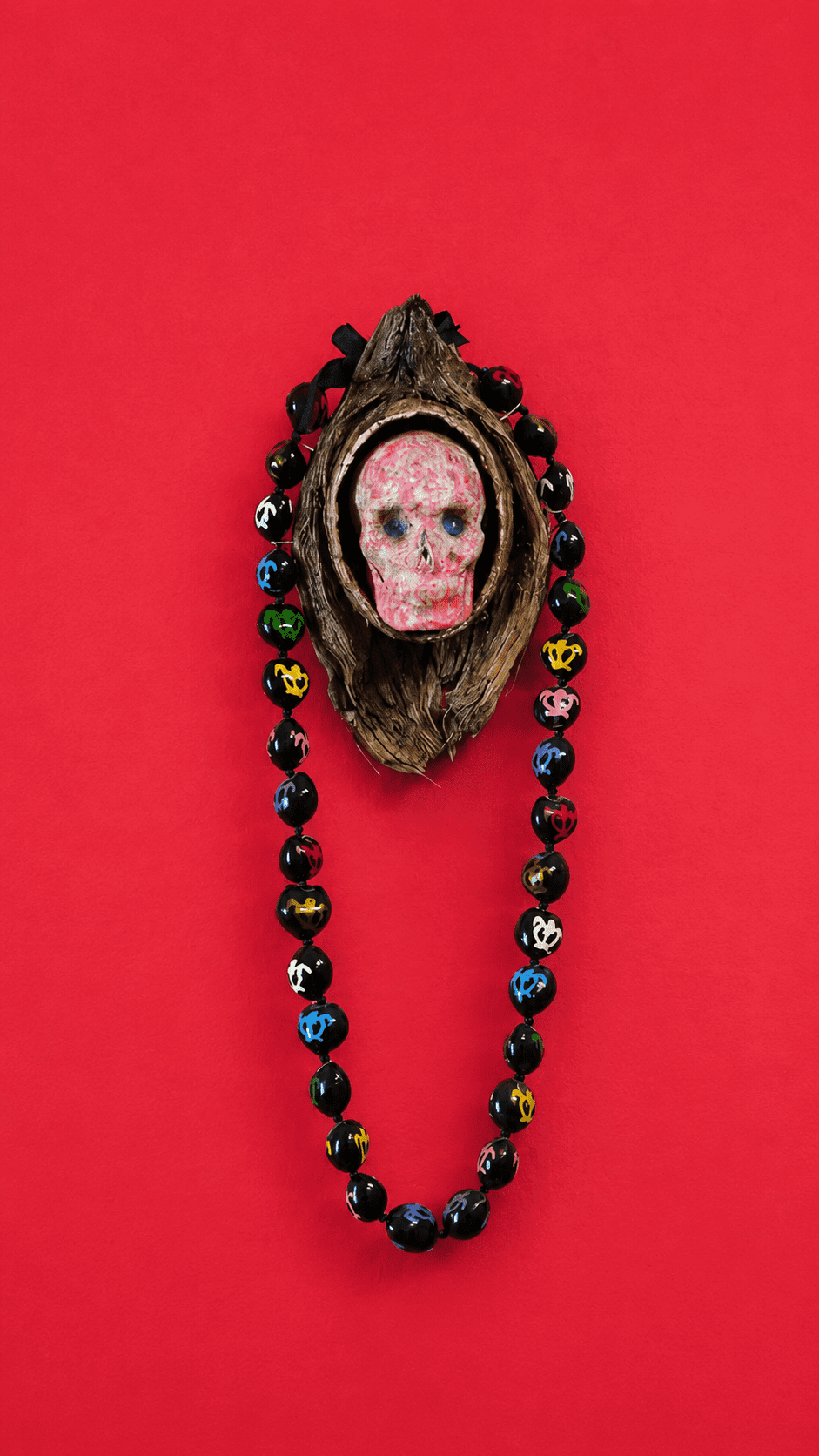 Lawrence Seward Old Wax Skull with Kukui, 2022 Coconut, surfboard wax, kukui nut lei, copper 18 x 6 1/2 x 4 inches (45.7 x 16.5 x 10.2 cm)